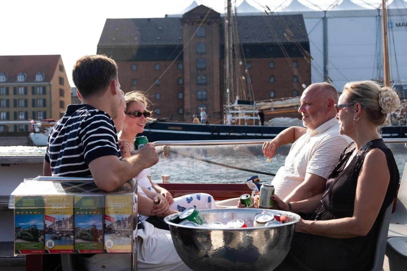Guests with drinks on deck beside an ice bucket