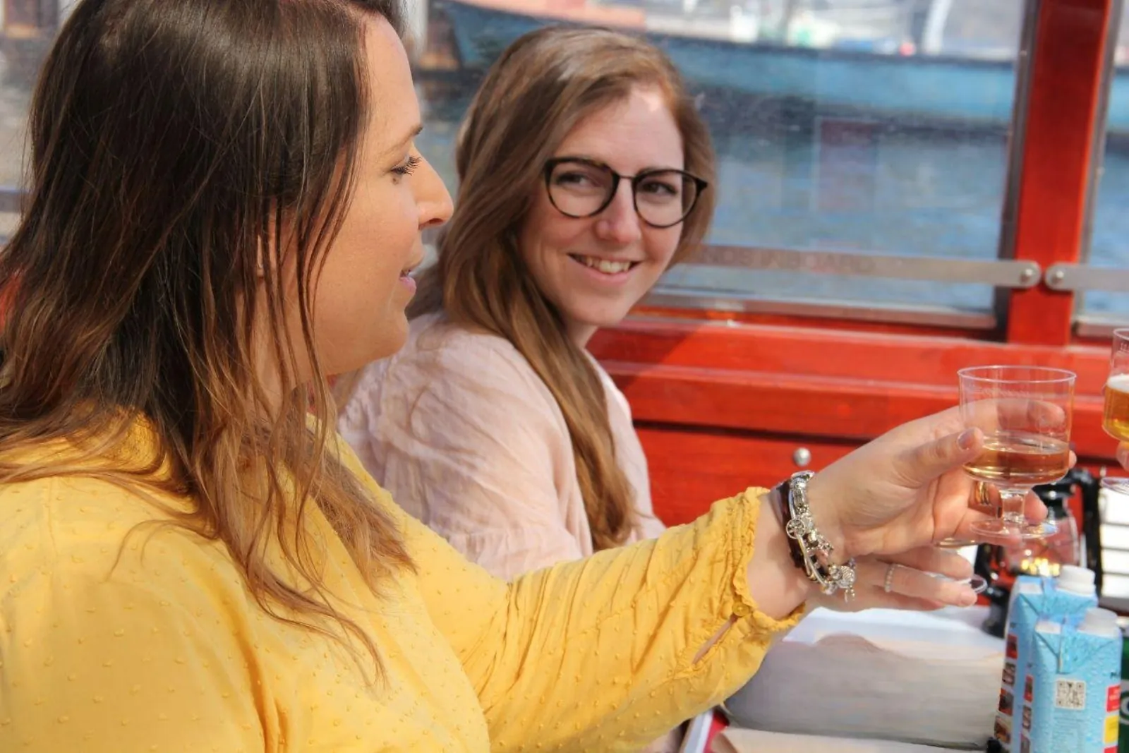 Two friends toasting with wine on the Sip & Sail cruise