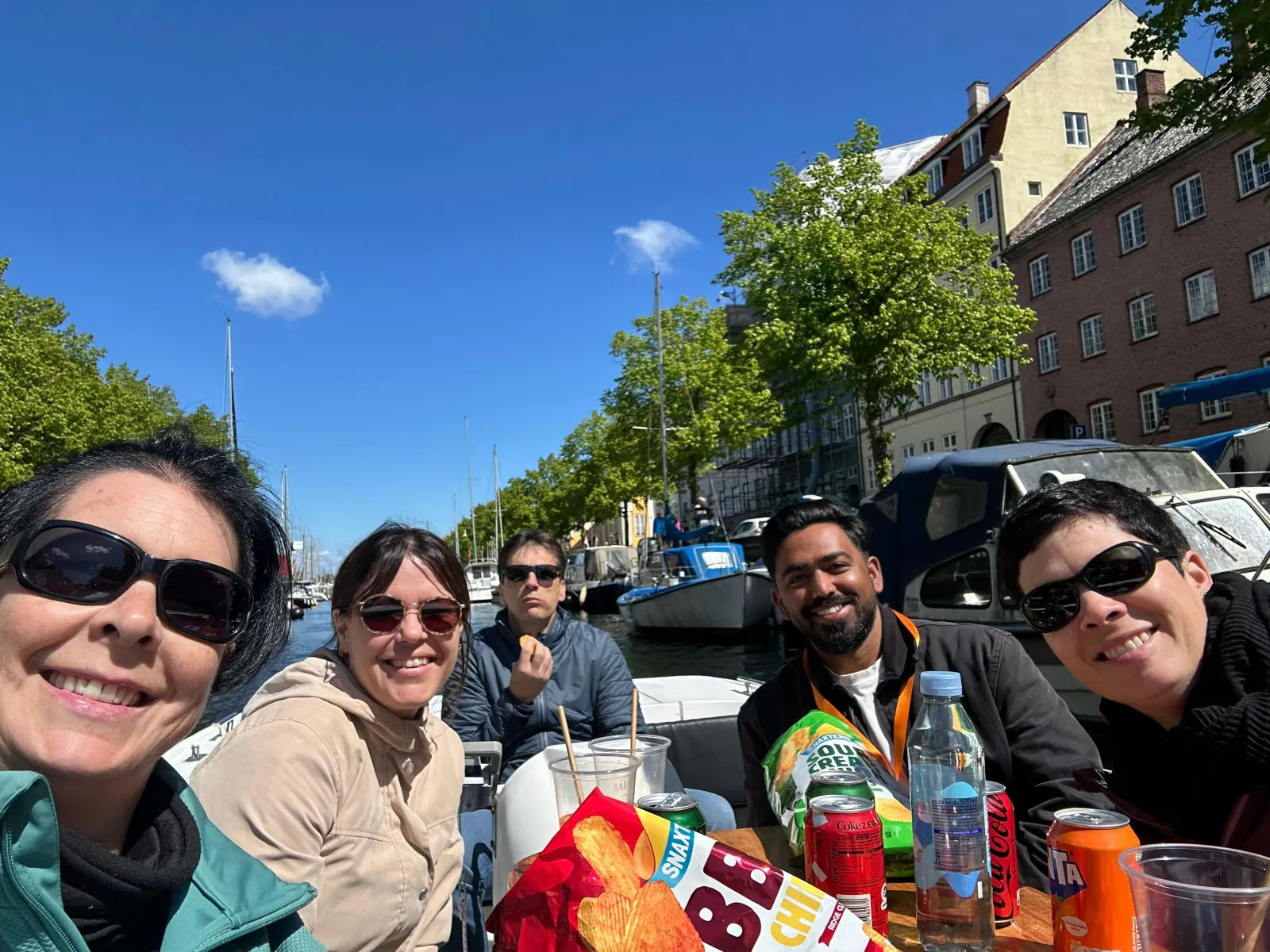 Guests sharing snacks and drinks on the boat