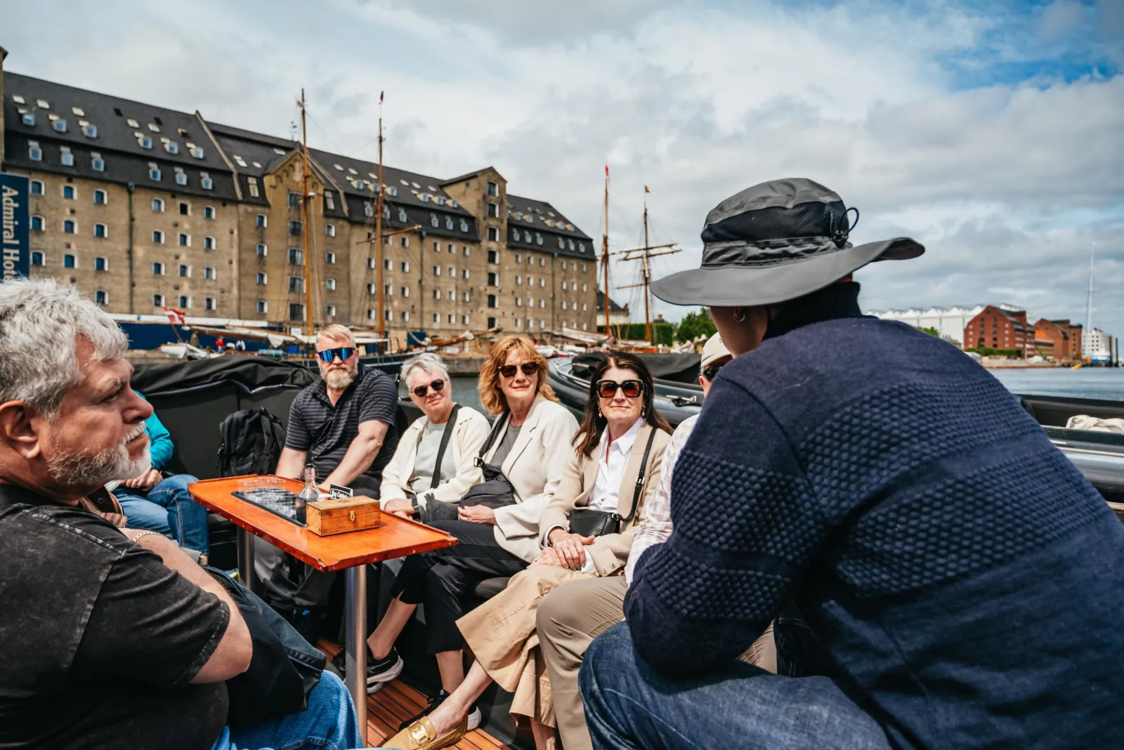 Guests chatting around the table on a Hey Captain boat