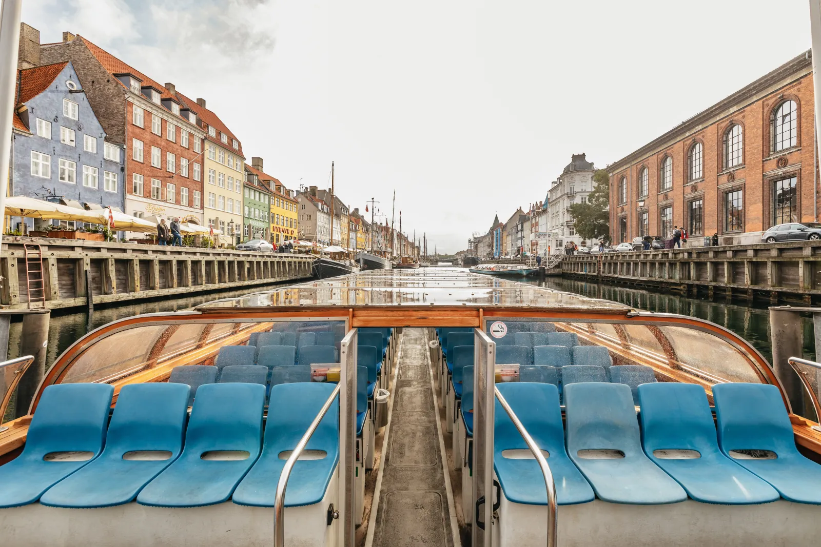 View down the blue seats of a canal boat towards Nyhavn