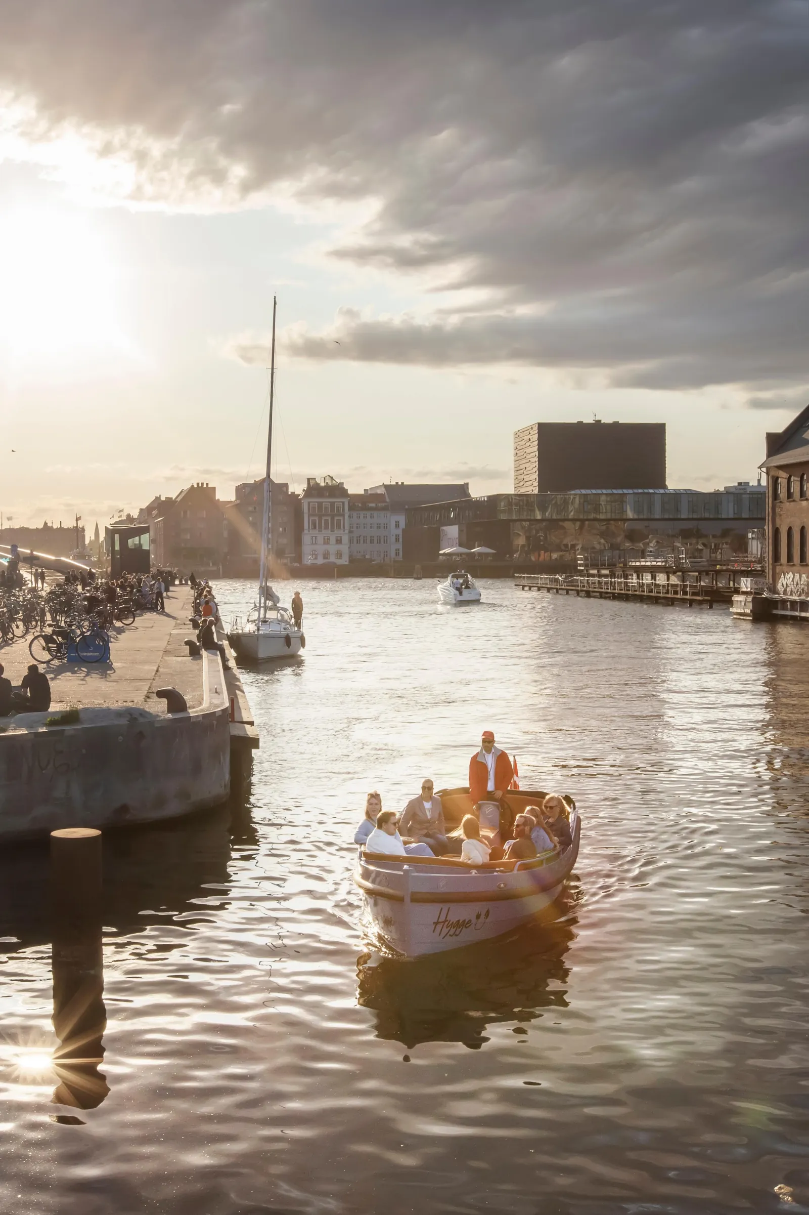 A small electric boat on the harbour at sunset