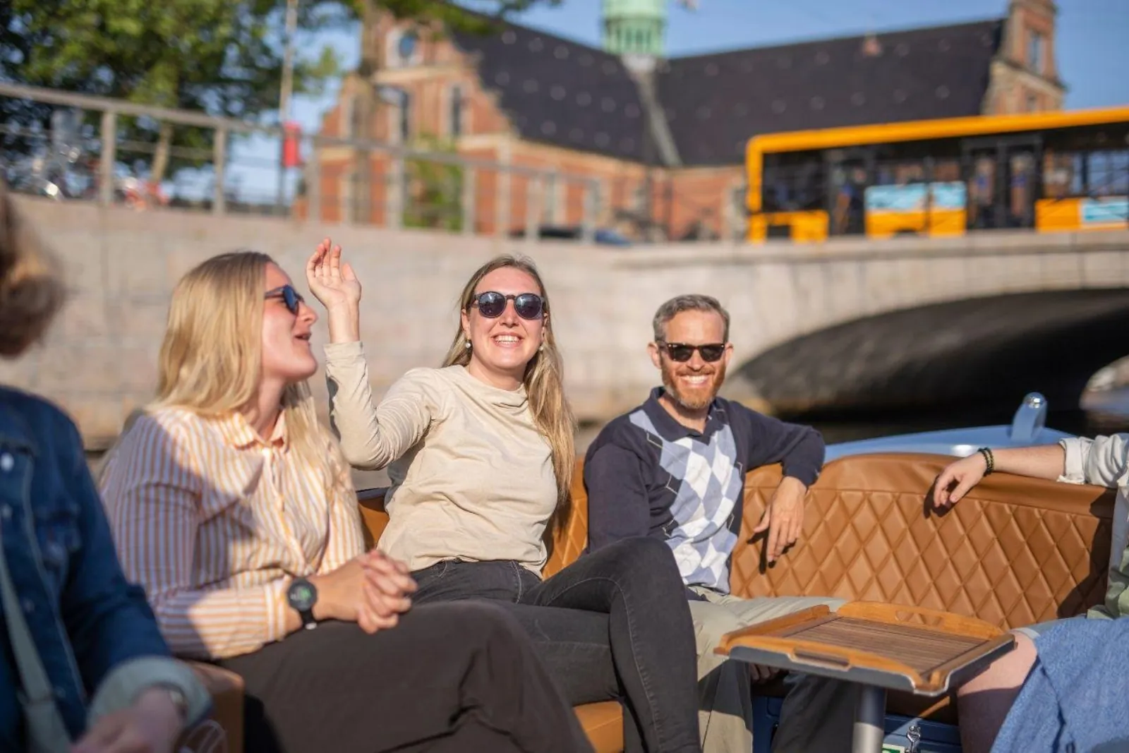 Guests laughing on the boat's leather seats