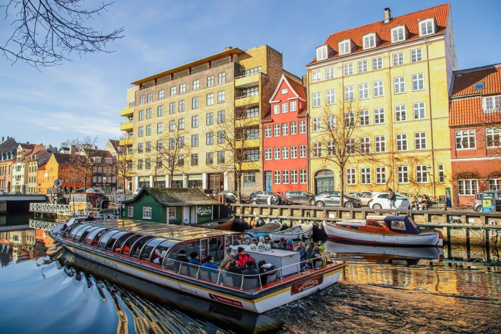 A canal boat passing the colourful houses of Nyhavn