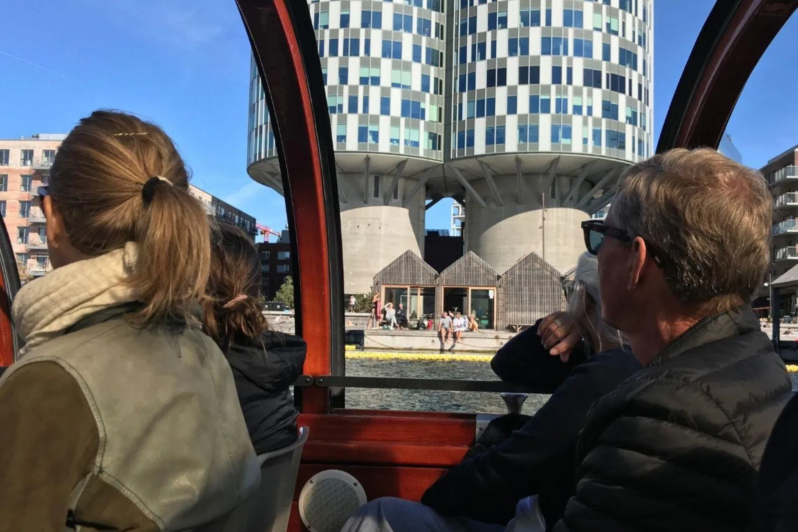 Passengers looking out through the glass sides of the boat