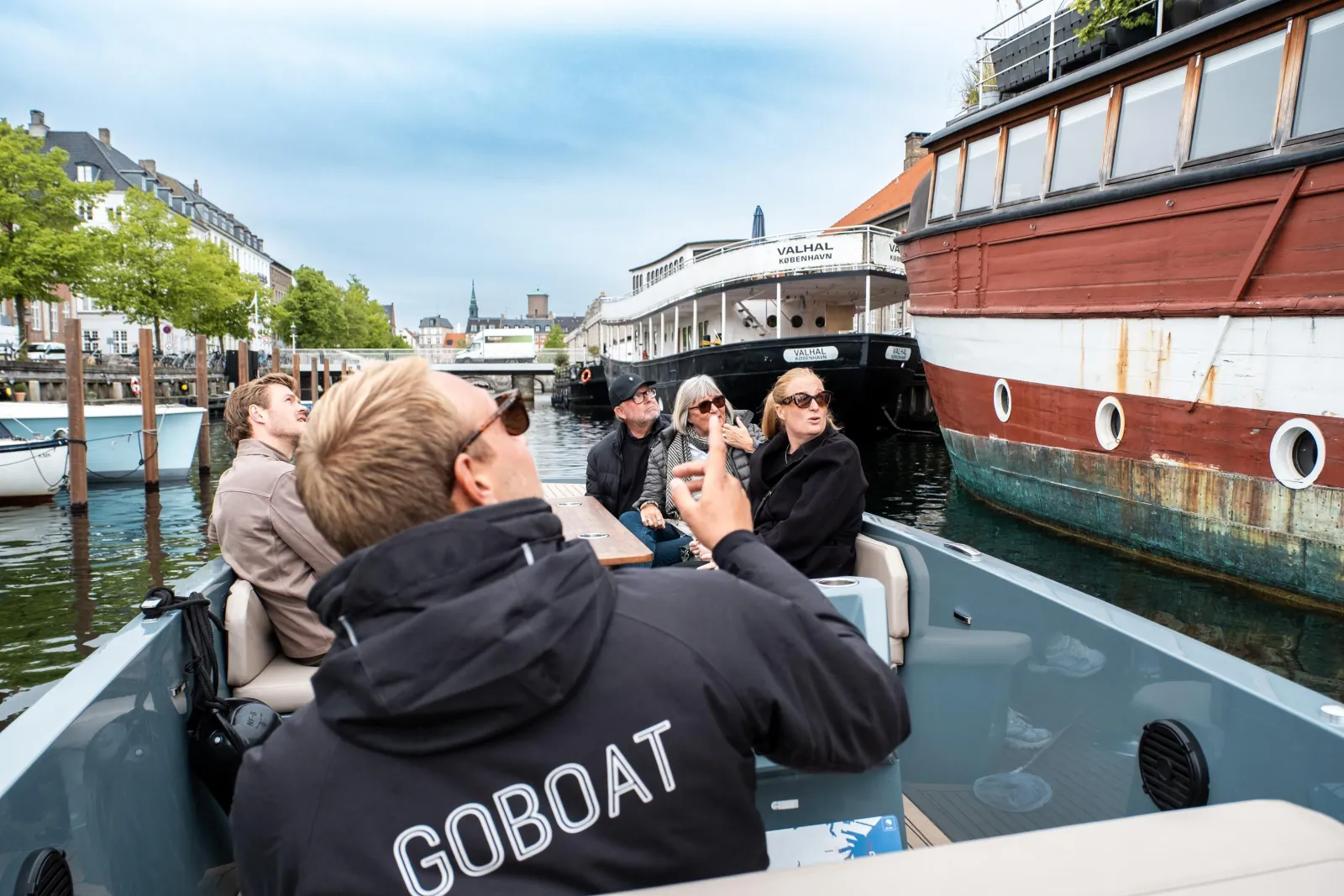 The GoBoat captain at the wheel with guests in front