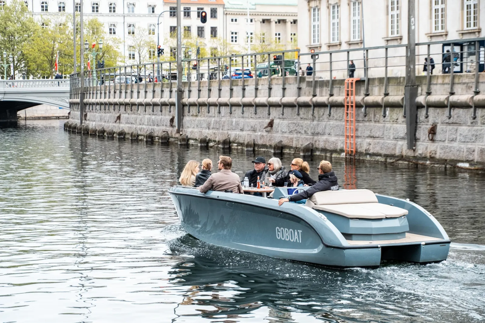 A GoBoat cruising along a tree-lined canal
