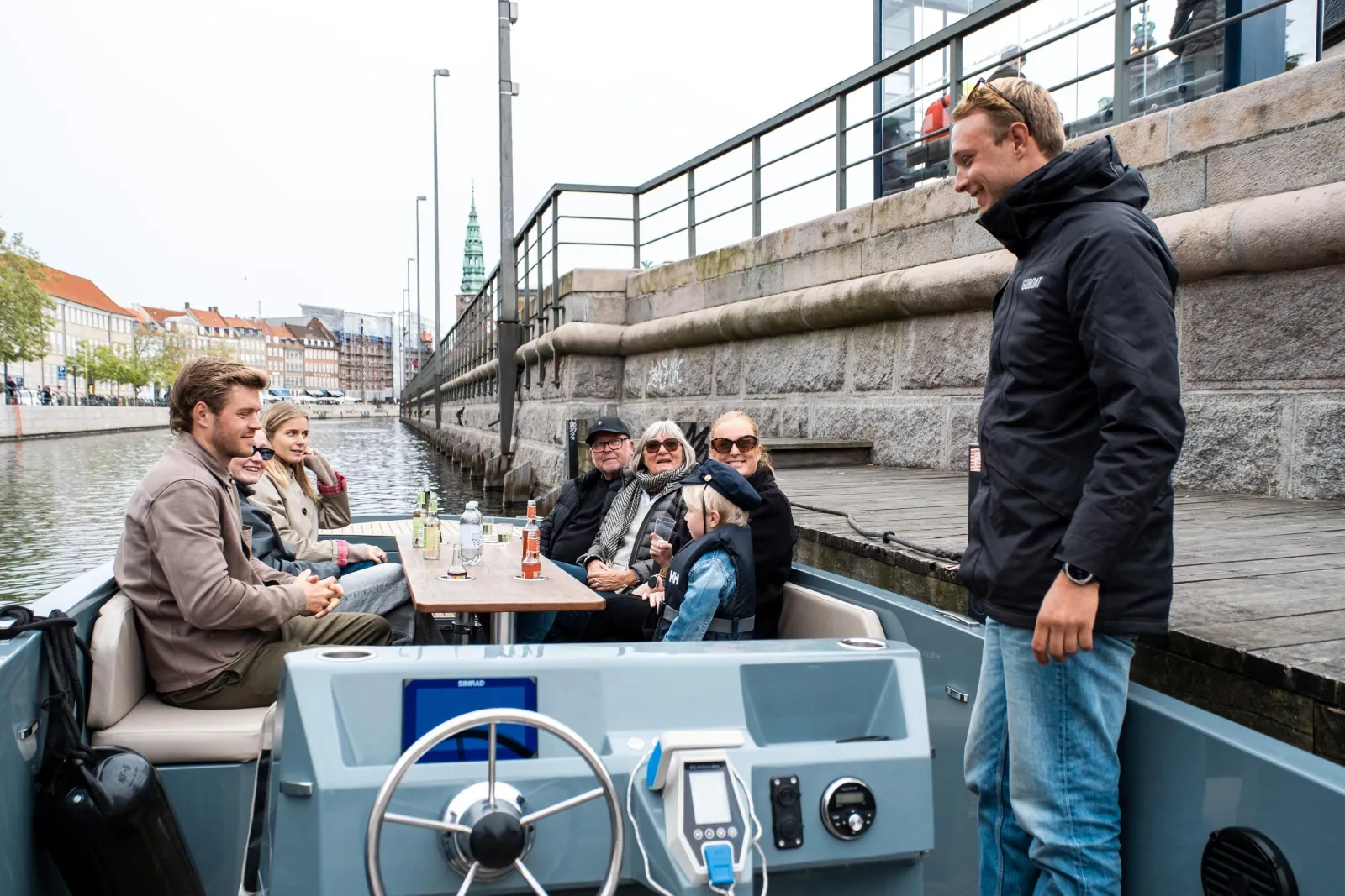 A GoBoat crew member welcoming guests at the jetty