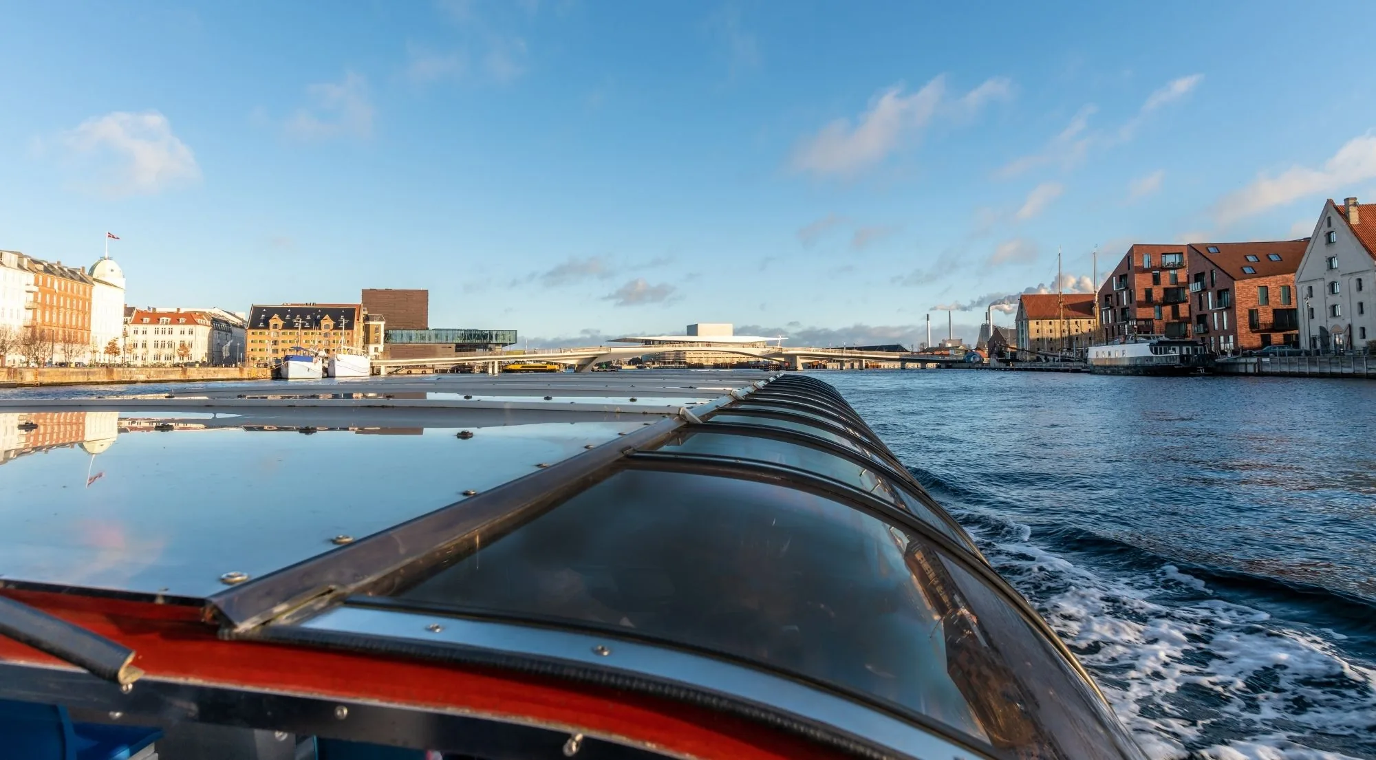 The harbour and the Opera House seen over the bow of a canal boat