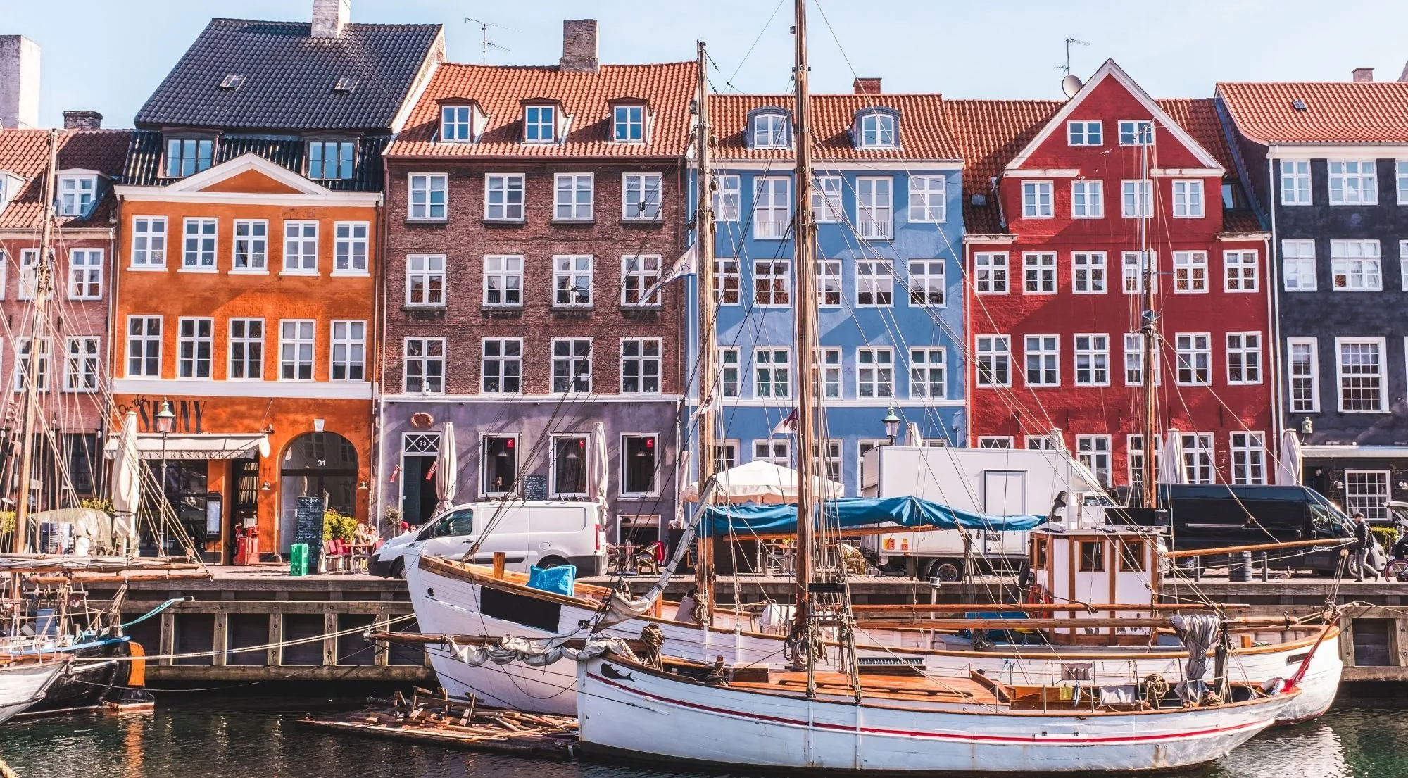 Coloured townhouses and moored sailing boats along Nyhavn